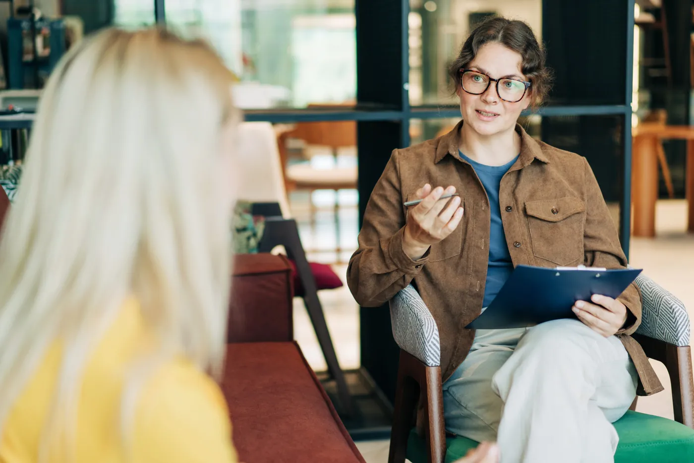 A counselor talking with a client in a bright office