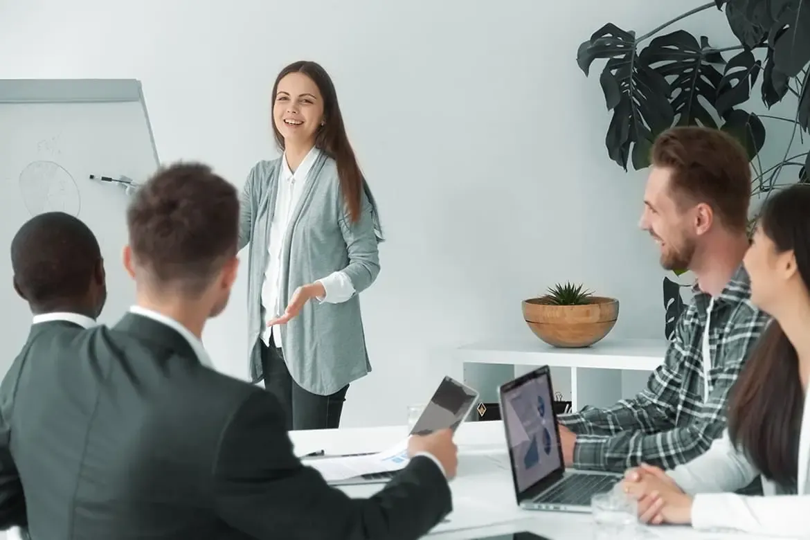 A team meeting around a laptop